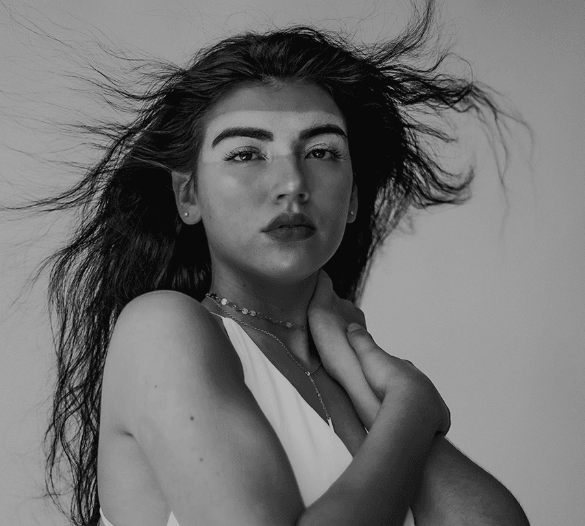 Black and white portrait of a dance instructor against a light background.
